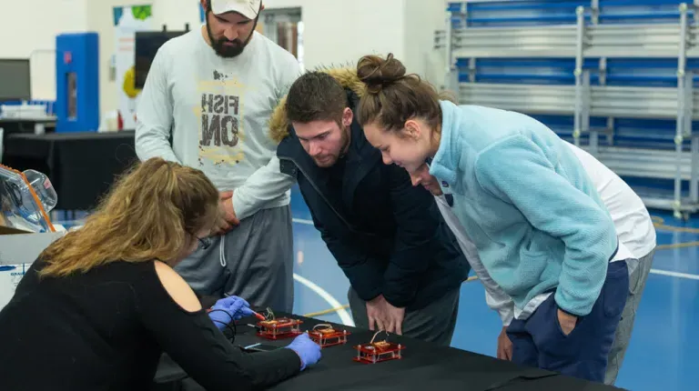 Three students learning about circuitry at a U N E Brain Fair