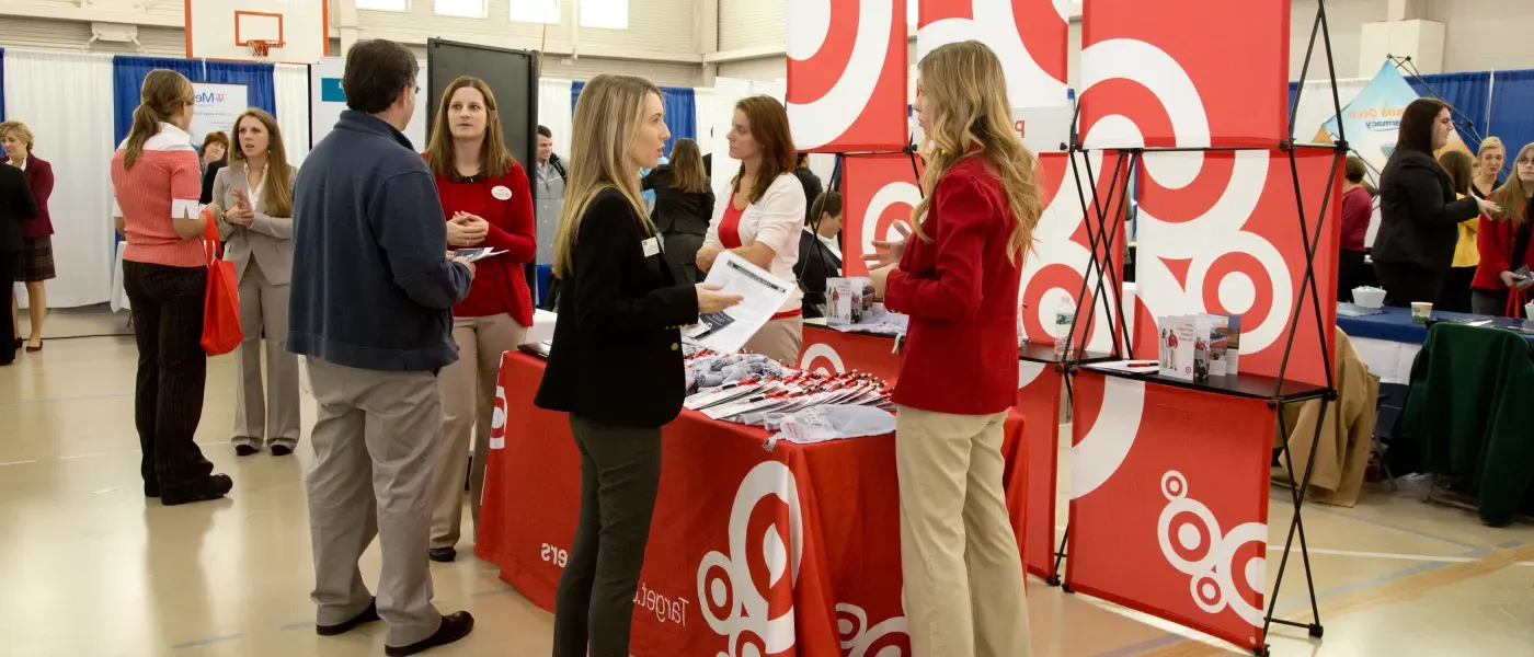 Students visit with health professionals during a career fair on U N E's Portland Campus 